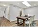 Bright dining room featuring a wooden table with chairs, skylight, and light wood flooring at 9309 Golden Woods Dr, Indianapolis, IN 46268