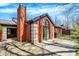 Beautiful brick home with a patio and unique architectural details including a chimney and arched window at 9309 Golden Woods Dr, Indianapolis, IN 46268