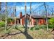 Lovely brick home surrounded by mature trees and landscaping, providing privacy and a natural setting at 9309 Golden Woods Dr, Indianapolis, IN 46268