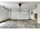 Spacious garage with white door, overhead lighting, and concrete floor, ready for parking and storage at 9309 Golden Woods Dr, Indianapolis, IN 46268