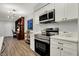 Updated kitchen featuring stainless steel appliances, white cabinets, and breakfast bar at 9309 Golden Woods Dr, Indianapolis, IN 46268