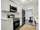 Modern kitchen with stainless steel appliances, white cabinets, and a breakfast nook at 9309 Golden Woods Dr, Indianapolis, IN 46268