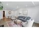 Inviting living room features a comfortable gray sofa, area rug, and access to other rooms at 9309 Golden Woods Dr, Indianapolis, IN 46268