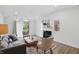 Open living room with a fireplace, comfortable seating, and bright natural light at 9309 Golden Woods Dr, Indianapolis, IN 46268