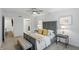 Serene main bedroom with a ceiling fan, bench, neutral colors, and hardwood floors at 9309 Golden Woods Dr, Indianapolis, IN 46268