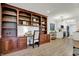 Open concept living and office area with hardwood floors and a built-in bookcase at 9309 Golden Woods Dr, Indianapolis, IN 46268