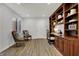 Cozy office space featuring custom built-in shelves, desk, and comfortable seating area at 9309 Golden Woods Dr, Indianapolis, IN 46268