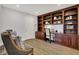 Bright office space featuring a large built-in bookshelf and desk at 9309 Golden Woods Dr, Indianapolis, IN 46268
