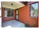 Covered porch featuring brick accents, windows, and the main entry door at 9309 Golden Woods Dr, Indianapolis, IN 46268