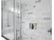 Updated shower with marble-look tile and recessed storage at 9309 Golden Woods Dr, Indianapolis, IN 46268