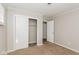 Bedroom features include carpet, and a closet with sliding doors for convenient storage at 9535 E Michigan St, Indianapolis, IN 46229