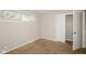 Neutral bedroom featuring carpet floors, a closet with sliding doors, and a window for natural light at 9535 E Michigan St, Indianapolis, IN 46229