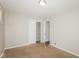 A bedroom featuring carpeted flooring, a closet, and a door leading to another room at 9535 E Michigan St, Indianapolis, IN 46229