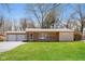 Charming single story home featuring a brick facade, attached garage, and a well-maintained front lawn at 9535 E Michigan St, Indianapolis, IN 46229