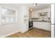 Kitchen featuring white cabinets, granite countertops, stainless steel appliances and laminate floors at 9535 E Michigan St, Indianapolis, IN 46229