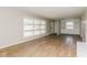 Bright living room featuring laminate flooring, built-in shelving and a large window at 9535 E Michigan St, Indianapolis, IN 46229