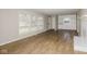 Bright living room featuring laminate flooring, built-in shelving and a large window at 9535 E Michigan St, Indianapolis, IN 46229