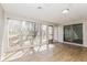Sunroom filled with windows, hardwood flooring, a door to the exterior, and lots of natural light at 9535 E Michigan St, Indianapolis, IN 46229