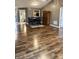Open concept dining area featuring modern hardwood floors and a large wooden cabinet at 9671 Trail Dr, Avon, IN 46123