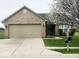Charming brick home featuring an attached two-car garage and a well-manicured lawn at 9671 Trail Dr, Avon, IN 46123