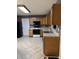 Well-lit kitchen featuring modern appliances, and laminate countertops with oak cabinets at 9671 Trail Dr, Avon, IN 46123