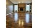 Spacious living room featuring hard wood floors and brick fireplace with abundant natural light at 9671 Trail Dr, Avon, IN 46123