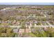 Aerial view of homes with mature trees, streets, and nearby community sports fields at 9814 E 17Th St, Indianapolis, IN 46229