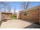 Concrete back patio area with access to the yard, partially screened by a wooden fence at 9814 E 17Th St, Indianapolis, IN 46229