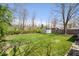 Large backyard featuring a shed and lush lawn at 9814 E 17Th St, Indianapolis, IN 46229