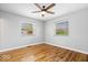 Empty bedroom features hardwood floors, neutral walls, and a ceiling fan at 9814 E 17Th St, Indianapolis, IN 46229