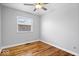 Bedroom features hardwood floors, neutral walls, and natural light at 9814 E 17Th St, Indianapolis, IN 46229