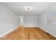 Open living room showcasing hardwood floors, neutral walls, and ample natural light streaming through the window at 9814 E 17Th St, Indianapolis, IN 46229