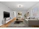 Bright living room featuring hardwood floors, modern decor, and a comfortable seating arrangement at 9814 E 17Th St, Indianapolis, IN 46229