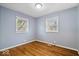 Bedroom featuring hardwood floors, a window, neutral paint, and a ceiling light at 102 Florence Dr, Greenwood, IN 46143