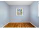 Neat bedroom with hardwood floors, a window providing natural light, and neutral paint at 102 Florence Dr, Greenwood, IN 46143