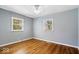 Bedroom with hardwood floors, neutral paint, and windows that provide plenty of natural light at 102 Florence Dr, Greenwood, IN 46143