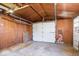 Spacious garage featuring wood paneling and a white door at 102 Florence Dr, Greenwood, IN 46143