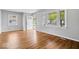 Bright and airy living room boasts hardwood floors, neutral walls, and plenty of natural light at 102 Florence Dr, Greenwood, IN 46143