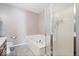 Bathroom with a shower, soaking tub, and neutral color palette at 10883 Balfour Dr, Noblesville, IN 46060