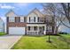 Charming brick two-story home with a well-manicured lawn and inviting front porch at 10883 Balfour Dr, Noblesville, IN 46060