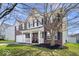 Attractive brick two-story house featuring a welcoming front porch and beautiful yard at 10883 Balfour Dr, Noblesville, IN 46060