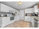 Well-maintained kitchen with white cabinetry, granite countertops, and tiled floors at 10883 Balfour Dr, Noblesville, IN 46060