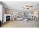 Inviting living room features a fireplace, ceiling fan, and a large comfortable sectional sofa at 10883 Balfour Dr, Noblesville, IN 46060