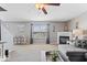 Open concept living room features a fireplace, ceiling fan, and plenty of natural light at 10883 Balfour Dr, Noblesville, IN 46060