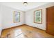 Bright bedroom with hardwood floors, white walls, and two windows letting in natural light at 1327 Lindberg Rd, Anderson, IN 46012