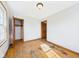 Bedroom with wood floors, closet, and wooden trim around the door and windows at 1327 Lindberg Rd, Anderson, IN 46012