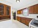 Traditional kitchen featuring wood cabinets, white countertops, and neutral tile flooring at 1327 Lindberg Rd, Anderson, IN 46012