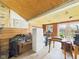 Unfinished storage room with wood paneling, exposed ceiling, and natural light at 1327 Lindberg Rd, Anderson, IN 46012