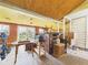 Unfinished storage room with exposed ceiling, wood paneling, and natural light at 1327 Lindberg Rd, Anderson, IN 46012