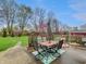 Charming backyard featuring an outdoor dining set and lush green lawn with trees and spring blossoms at 1331 Dunlap Ave, Indianapolis, IN 46241